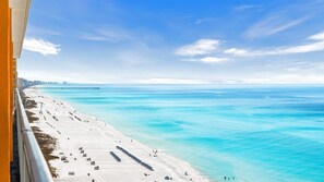 A beach with a pier extending into the ocean, a clear sky, and a white sandy shore. - Splash Resort Luxury * Pools / Lazy River / Water Parks * Sept still Available (Panama City Beach)