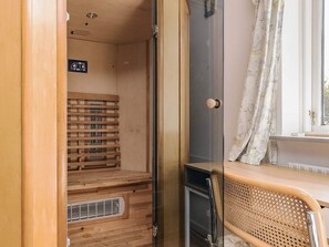 A compact RV interior with a kitchenette, a sleeping area with a bed, and a small window with curtains. - 10 Person Holiday Home in Spottrup (Spøttrup)