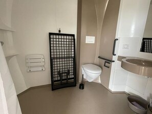 A small bathroom with a toilet, a sink, and a shower area. - Accessible mobile home, 4 guests (Saint-Lunaire)