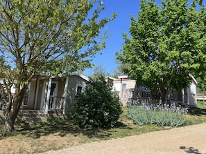A residential area with houses, a driveway, and a well-maintained lawn. - Chalet pets welcome - 5 guests (Saint-Georges-de-Luzençon)