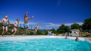 A swimming pool with people around it.