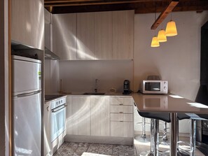 A compact kitchen with a modern design, featuring a built-in oven, a microwave, and a sink. - Perfect duplex. Fireplace and swimming pool in summer - Herbasabina 4 (Pla de l'Ermita)