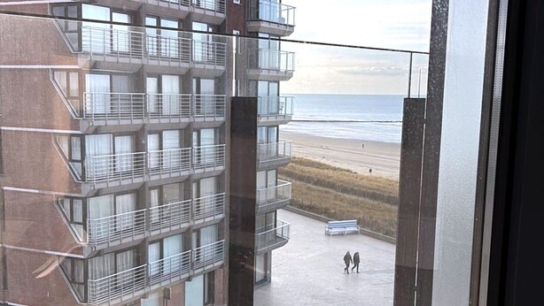 A multi-story building with balconies overlooking a beach. - Luxury Apartment With sea View (Middelkerke)