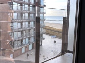 A multi-story building with balconies overlooking a beach. - Luxury Apartment With sea View (Middelkerke)