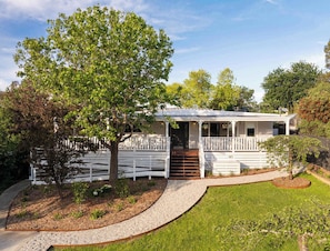 A white house with a porch, a tree in front, and a gravel pathway. - The Meadow Yarra Valley Spa Sauna (Yarra Glen)
