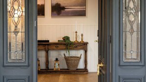 A wooden console table with a basket, candles, and a plant. - The Meadow Yarra Valley Spa Sauna (Yarra Glen)