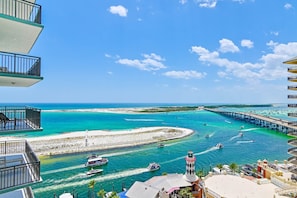 A coastal view with a pier, boats, and a lighthouse. - Breathtaking Views Emerald Grande 3BR/2BA 904E (Destin)