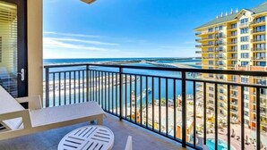 A balcony with a view of the sea and a resort area. - Breathtaking Views Emerald Grande 3BR/2BA 904E (Destin)