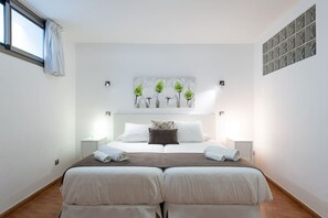 A double bed with two pillows, a bedside table, a wall-mounted artwork, and a window with curtains. - Villa del Sur - Luxury with heated pool and BBQ (Mogán)
