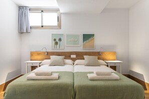 A double bed with two nightstands, a window with curtains, and wall art. - Villa Chil - Luxury with heated pool and BBQ (Mogán)