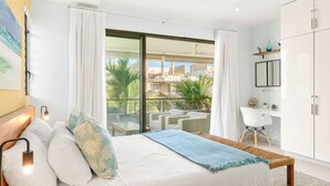 A bedroom with a bed, a desk, a chair, and a view of the outside. - Element penthouse with private pool near the beach (Cap Malheureux)