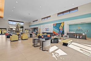 A spacious lobby with modern furniture, a Christmas tree, and a sign for the Aquarius Clubhouse. - PG6043 - 15BR Amazing house near Disney (Orlando)