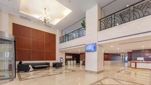 A spacious lobby with a reception desk, seating area, and a staircase to an upper level. - Shanghai Bund Suhepan Apartment (Shanghai)