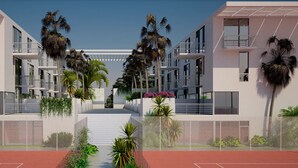 A modern building with multiple balconies, a central staircase, and surrounding palm trees. - Luxury Tennis Retreat Near Siesta Key, Bath and Racquet Club. Sleeps 4. (Sarasota)