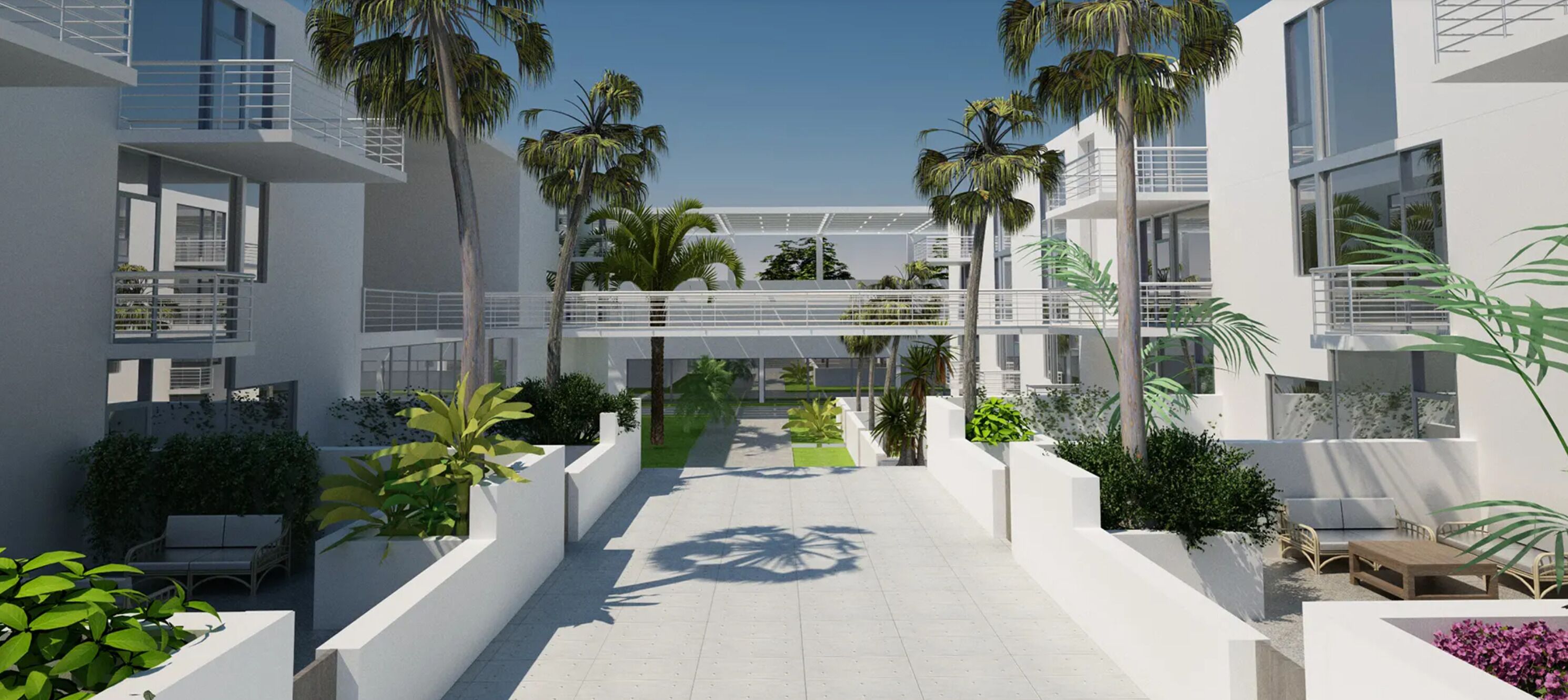 Un bâtiment moderne doté de nombreux balcons, de murs blancs et d’une végétation luxuriante.