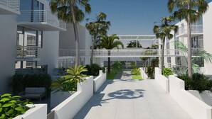 A modern building with multiple balconies, white walls, and lush greenery. - Luxury Tennis Retreat Near Siesta Key, Bath and Racquet Club. Sleeps 4. (Sarasota)