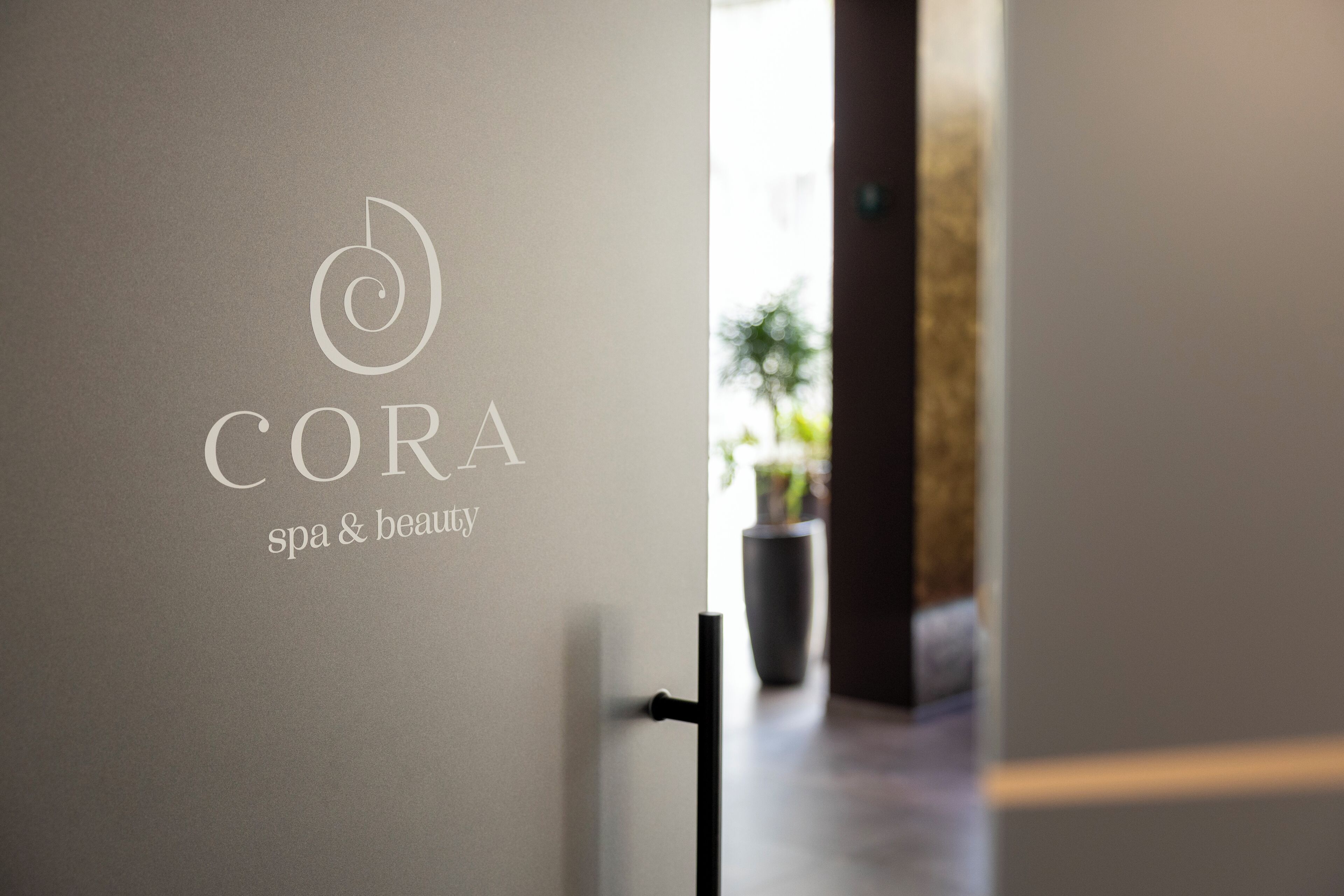 A door with a logo and text indicating a spa and beauty establishment.