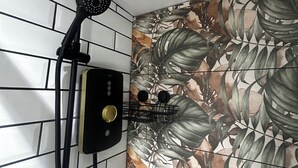 A shower with a handheld showerhead and a wall-mounted rain showerhead, a control panel, and a towel rack. - Comfortable 1-bed Chester Apartment with Parking & Full Kitchen, Home from Home (Chester)