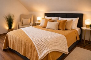A bedroom with a large bed, two bedside tables with lamps, a chair, and a potted plant. - Arrive & Feel at Home • Fireplace • calm • Parking Lot (Paderborn)