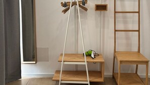 A room with a wooden shelf, a ladder, a mirror, and an air conditioning unit. - At Casuzza di Giù Giù: Experience your stay in the historic center of Agrigento! (Agrigento)