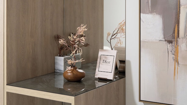 A modern room with a wooden cabinet, a vase with dried flowers, a framed picture, and a large abstract painting on the wall. - Spacious Family Duplex- The Shouk House (Jerusalem)