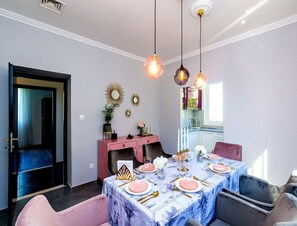 A dining room with a table set for six, a pink console table, and decorative mirrors on the wall. - Rustic Stone Villa With Private Pool & Garden (Solin)