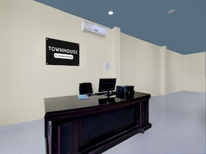 A reception desk with a sign reading 'TOWNHOUSE Company Serviced.'