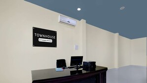 A reception desk with a sign indicating 'Townhouse Company Serviced.' - Deluxe Hotel Santosh Palace (Prayagraj)