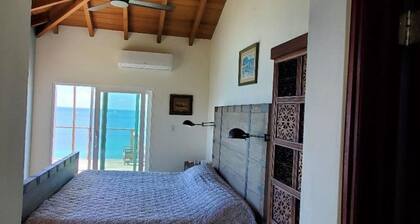 2-bedroom villa in VG; deck, pool, garden; endless ocean views; steps from beach