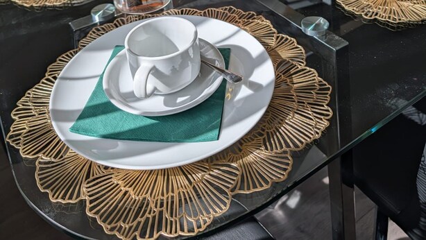 A dining table set with white plates, green napkins, and a variety of pastries and cookies. - Modern 3-Bed House Leeds | Sleeps 7 | Free Parking | Contractor Friendly | Wi-Fi (Leeds)