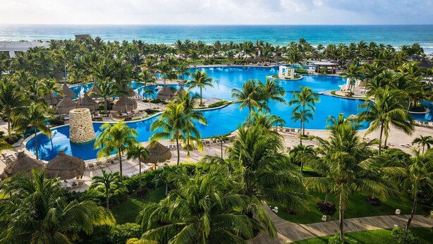 A resort with multiple swimming pools, palm trees, and a view of the ocean. - Grand Mayan Vidanta 2BR Luxury Suite + Pools & Beach (Playa Paraiso)