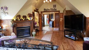 A spacious loft with a fireplace, a television, and a dining area. - "The Love Nest" - Stunning Views overlooking the Shenandoah in Wine Country (Markham)