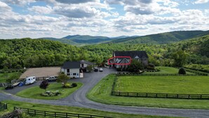 A rural property with a large house, a barn, and a fenced pasture. - "The Love Nest" - Stunning Views overlooking the Shenandoah in Wine Country (Markham)