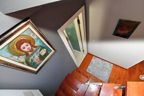 A staircase with wooden steps, a framed painting on the wall, and a door leading to another room. - Taksim Private Terrace Near Museum of Innocence (Istanbul)