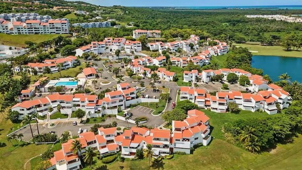 Ein Resort mit mehreren Gebäuden, einem Swimmingpool und einem See.