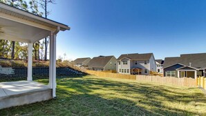 A residential area with houses, a covered porch, and a grassy yard. - The Masters 2027 Rental: Coming Soon! (Lexington)