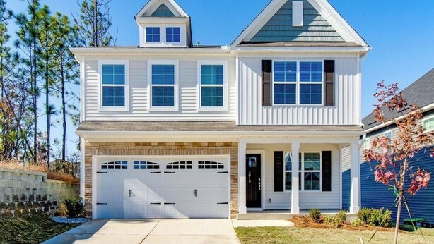 A two-story house with a garage, a covered porch, and a small attached garage. - The Masters 2027 Rental: Coming Soon! (Lexington)
