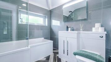 Combined shower/bathtub, deep-soaking bathtub, towels