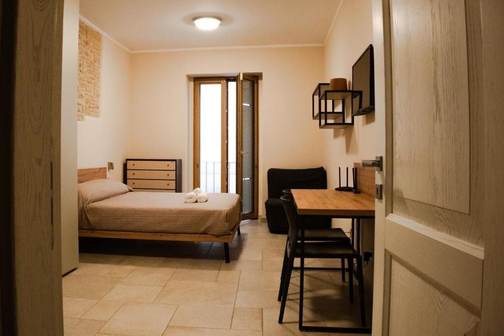 Ein Schlafzimmer mit einem Bett, einem Schreibtisch und einem Stuhl.