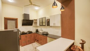 Uma cozinha moderna com armários de madeira, bancada de mármore e forno embutido.