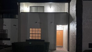 A modern building with a large window, a door, and a small outdoor seating area. - Hotel Style 1-bedroom in lovely Orlando with AC (Orlando)