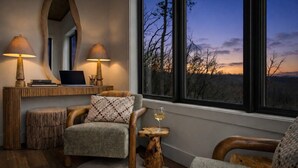 A cozy room with a large window, a desk with a laptop, two lamps, and a chair with a glass of wine. - 2+m villa/NordicSpa/StargazingDome/Skylounge/Epic view/Pool/minigolf/Microevents (Sevierville)