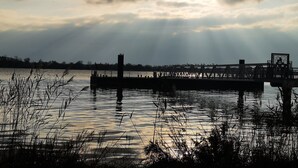 A bridge over water with a cloudy sky. - Port House (Bourg)
