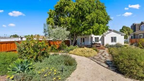 A house with a garden, a pathway, and a fence. - The Wild Flower by Coastline Vacation Rentals (San Diego)