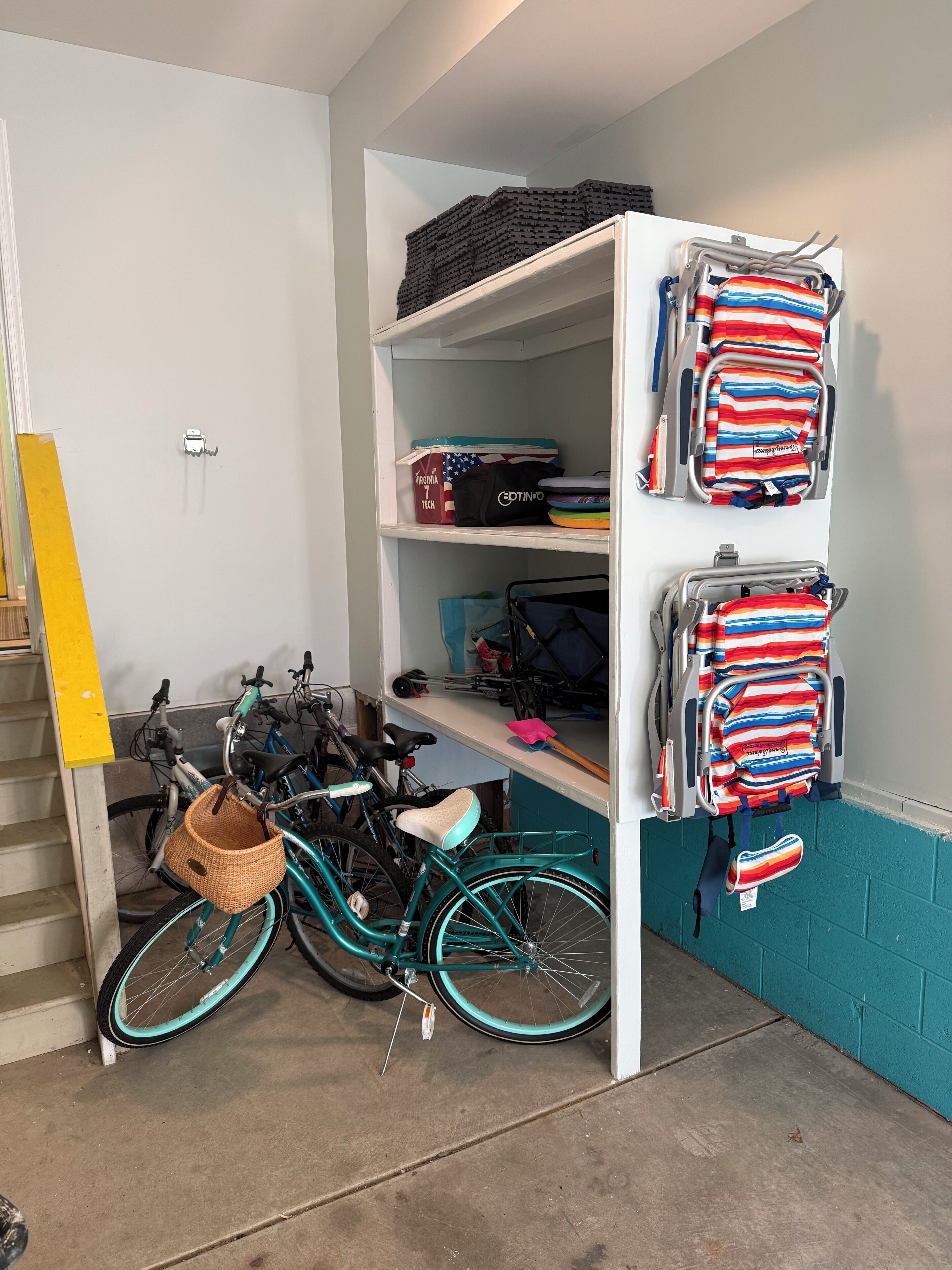 A storage area with shelves holding bags and a bicycle.