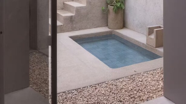 A concrete staircase leading to a small pool with pebbles at the bottom. - Meridiano 48 Loft, One-Bedroom Accommodation (Mérida)
