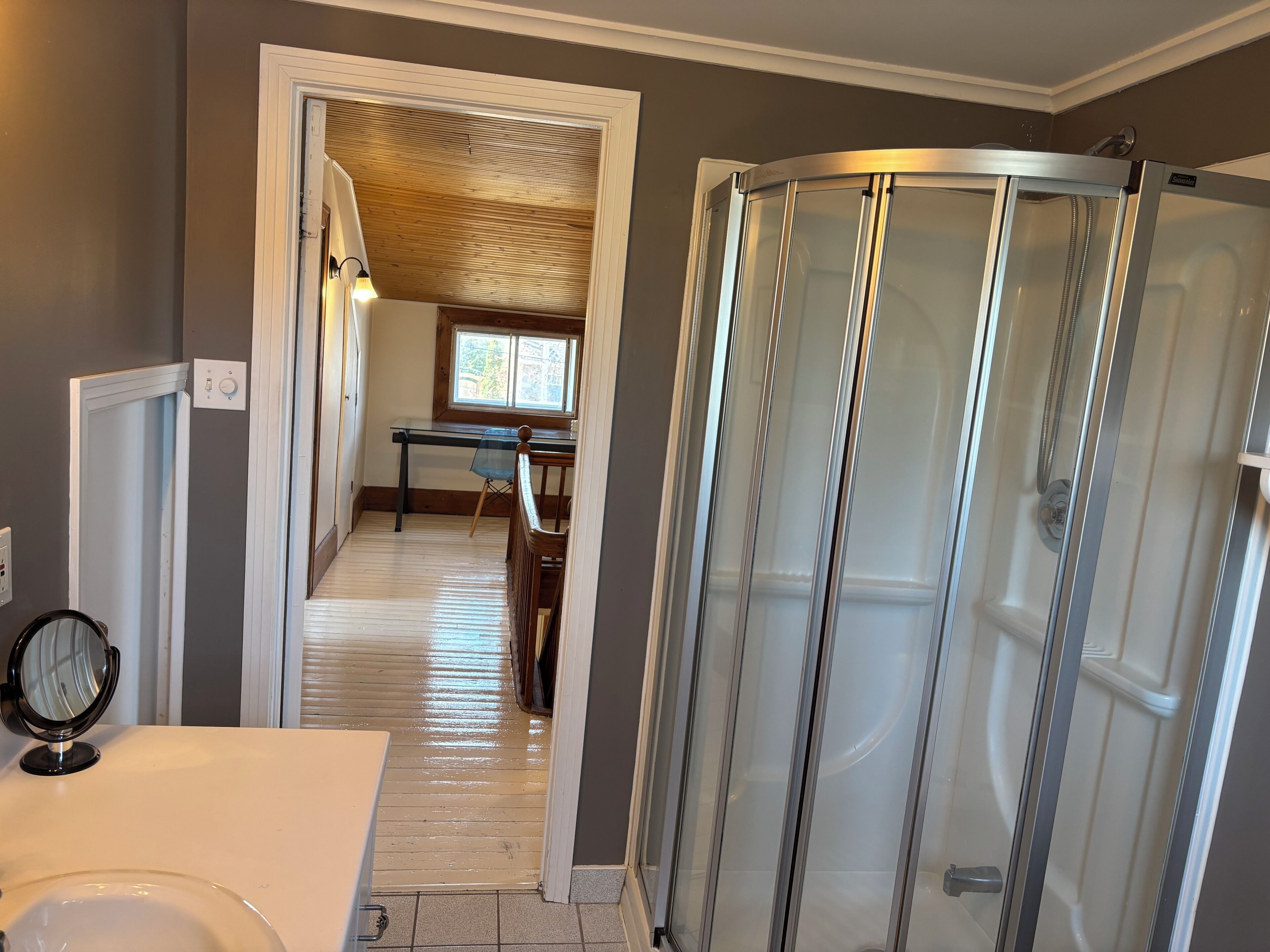 A bathroom with a shower, a toilet, and a sink.