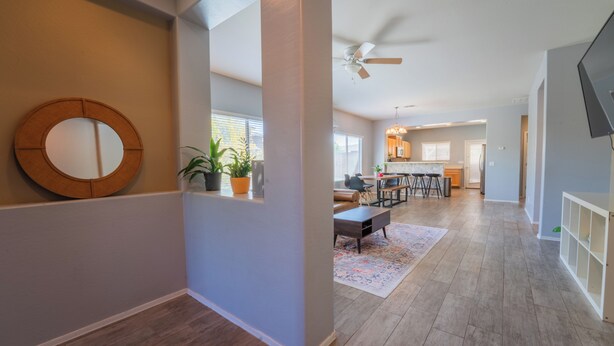 A spacious living area with a dining table, chairs, a ceiling fan, and a kitchen in the background. - 3-bedroom 2 bath 1 office fully furnished Florence House (Florence)