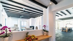 A modern interior with a wooden bar, seating area, and a view of the outdoors.