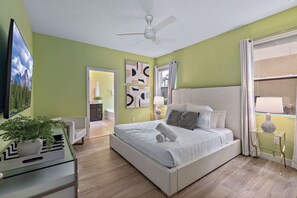 Your peaceful retreat awaits! Settle into a comfortable bed, enjoy a quiet evening watching TV, and recharge for another exciting day. This welcoming bedroom offers the perfect combination of comfort, privacy, and relaxation. - 6BR Themed Villa w/ Game Room+ Pool & Spa Solterra (Davenport)